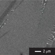 Figure 1: A scanning electron microscope image of a nano-structured thermoelectric material. This material is composed of two compounds, antimony telluride and lead telluride, which spontaneously form a layered structure when mixed. The lower image shows that the thickness of these layers is on the order of a few tens of nanometers (Ref 1)